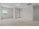 Spacious bedroom with neutral carpet, a window, and a glass-paned door to a balcony or patio at 2501 Macedonia Pine Dr, Raleigh, NC 27616