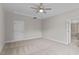 Bright carpeted bedroom with a fan and access to the main bathroom at 2501 Macedonia Pine Dr, Raleigh, NC 27616