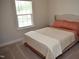 Cozy bedroom with a made bed near a window offering natural light, creating a comfortable ambiance at 2501 Macedonia Pine Dr, Raleigh, NC 27616