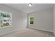 Bright bedroom with two windows offering natural light and a view of the home's exterior at 2501 Macedonia Pine Dr, Raleigh, NC 27616