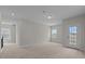 Large bonus room with carpet, window view, and access to exterior patio at 2501 Macedonia Pine Dr, Raleigh, NC 27616