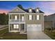 Charming two-story home with a covered front porch and a two-car garage at 2501 Macedonia Pine Dr, Raleigh, NC 27616