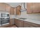 Close-up view of the kitchen's quartz countertops, gas range, and modern tile backsplash at 2501 Macedonia Pine Dr, Raleigh, NC 27616