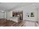 Open-concept living room with hardwood floors and a view of the kitchen with stainless steel appliances at 2501 Macedonia Pine Dr, Raleigh, NC 27616