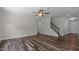 Large living room featuring hardwood floors, neutral decor, and a staircase leading to the upper level at 2501 Macedonia Pine Dr, Raleigh, NC 27616