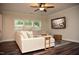 Living room featuring neutral decor, a large sectional sofa, and natural light from the large windows at 2501 Macedonia Pine Dr, Raleigh, NC 27616