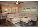 Spacious living area with comfortable seating, an adjacent kitchen/dining area, and large windows for natural light at 2501 Macedonia Pine Dr, Raleigh, NC 27616