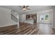 Open floor plan with stairs, kitchen, and living space, showcasing hardwood flooring and neutral paint at 2501 Macedonia Pine Dr, Raleigh, NC 27616