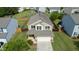 Aerial view of a two-story home featuring a two-car garage and mature landscaping at 2527 Girvan Dr, Fuquay Varina, NC 27526