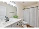 Well-lit bathroom with a single sink vanity, a framed mirror, and wood-look floors at 2527 Girvan Dr, Fuquay Varina, NC 27526