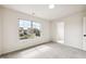 Well-lit bedroom with neutral carpet, large window, and a walk in closet at 2527 Girvan Dr, Fuquay Varina, NC 27526