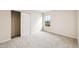 Cozy bedroom with a large window, spacious closet and neutral carpet flooring at 2527 Girvan Dr, Fuquay Varina, NC 27526