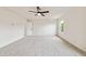 Bright bedroom featuring a ceiling fan, neutral carpet, and a sunny window at 2527 Girvan Dr, Fuquay Varina, NC 27526