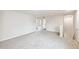 Bright bonus room featuring neutral walls, plush carpeting, and open doorway at 2527 Girvan Dr, Fuquay Varina, NC 27526