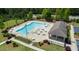 Aerial view of the community pool, showcasing the pool, chairs, tables and surrounding greenery at 2527 Girvan Dr, Fuquay Varina, NC 27526