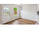 Dining area featuring access to backyard with contemporary lighting and wood flooring at 2527 Girvan Dr, Fuquay Varina, NC 27526