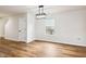 Dining room features lovely wood flooring and contemporary lighting, providing a modern aesthetic at 2527 Girvan Dr, Fuquay Varina, NC 27526