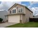 Two-story home featuring an attached two-car garage, neutral siding, and well-maintained lawn at 2527 Girvan Dr, Fuquay Varina, NC 27526
