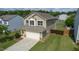 Aerial view of home showcasing 2-car garage, lawn, and surrounding neighborhood at 2527 Girvan Dr, Fuquay Varina, NC 27526