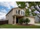 Charming two-story home featuring a well-manicured front yard and attached garage at 2527 Girvan Dr, Fuquay Varina, NC 27526