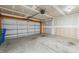 Spacious two car garage featuring concrete flooring and ample overhead lighting at 2527 Girvan Dr, Fuquay Varina, NC 27526