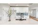 Close-up of a kitchen island with a stainless steel sink and quartz countertops at 2527 Girvan Dr, Fuquay Varina, NC 27526