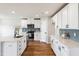 Modern kitchen with white cabinets, stainless steel appliances, and a quartz countertop island at 2527 Girvan Dr, Fuquay Varina, NC 27526