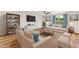 Cozy living room featuring hardwood floors, comfortable seating, and a large flat-screen television at 2527 Girvan Dr, Fuquay Varina, NC 27526