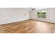 Living room with wood-look flooring, a ceiling fan, and natural light from the window at 2527 Girvan Dr, Fuquay Varina, NC 27526