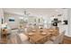 Open-concept living and dining area featuring hardwood floors and access to a modern kitchen at 2527 Girvan Dr, Fuquay Varina, NC 27526