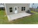Close-up aerial view of the backyard patio with brick border and well-maintained lawn at 2527 Girvan Dr, Fuquay Varina, NC 27526