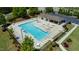 Aerial view of a community pool and clubhouse with ample lounge seating and parking at 2527 Girvan Dr, Fuquay Varina, NC 27526