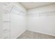 Walk-in closet featuring metal shelving and neutral carpet flooring at 2527 Girvan Dr, Fuquay Varina, NC 27526