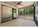 Screened-in porch featuring a wood deck, outdoor lighting and ceiling fan at 260 Pilot Ridge Rd, Zebulon, NC 27597