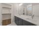 Elegant bathroom featuring a double sink vanity, a large mirror and walk-in closet at 260 Pilot Ridge Rd, Zebulon, NC 27597