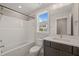 Bathroom features a single vanity with neutral walls, tub-shower, and tiled floors at 260 Pilot Ridge Rd, Zebulon, NC 27597