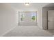 Carpeted bedroom features two bright windows, neutral walls, and modern trim at 260 Pilot Ridge Rd, Zebulon, NC 27597