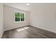 Bedroom features a bright window, neutral walls, and wood-look flooring, offering a serene space at 260 Pilot Ridge Rd, Zebulon, NC 27597