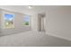 Bright bedroom with plush carpet and natural light from two windows at 260 Pilot Ridge Rd, Zebulon, NC 27597