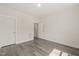 Well-lit bedroom featuring neutral-toned walls, wood-look floors, and closet and ensuite access at 260 Pilot Ridge Rd, Zebulon, NC 27597