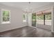 Bright dining area featuring wood floors, two windows, and sliding doors to the outdoor living area at 260 Pilot Ridge Rd, Zebulon, NC 27597
