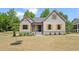 Charming home featuring board and batten siding, natural wood shutters, and a well-manicured lawn at 260 Pilot Ridge Rd, Zebulon, NC 27597