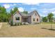 Craftsman style home with light gray siding, orange shutters, and a stone foundation at 260 Pilot Ridge Rd, Zebulon, NC 27597