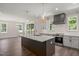 Open-concept kitchen with an island, stainless steel appliances, and backyard views at 260 Pilot Ridge Rd, Zebulon, NC 27597