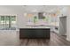 Modern kitchen with a dark island, stainless steel appliances, and stylish pendant lighting at 260 Pilot Ridge Rd, Zebulon, NC 27597