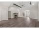 Open-concept living room with wood beams, fireplace, and luxury vinyl plank flooring at 260 Pilot Ridge Rd, Zebulon, NC 27597