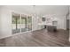 Open-concept living space with modern kitchen, stylish lighting, and sliding door access to the outdoor porch at 260 Pilot Ridge Rd, Zebulon, NC 27597