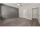 Bright and airy bedroom with a feature accent wall, wood floors and ensuite bathroom at 260 Pilot Ridge Rd, Zebulon, NC 27597
