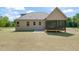 Rear exterior of a house with a screened porch, concrete patio, and newly installed lawn at 260 Pilot Ridge Rd, Zebulon, NC 27597
