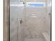 Modern shower featuring white tile surround, a glass door, and a built-in bench at 260 Pilot Ridge Rd, Zebulon, NC 27597